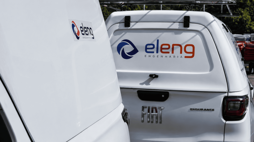 Parte traseira de dois veículos brancos da Eleng com adesivo do logotipo da empresa